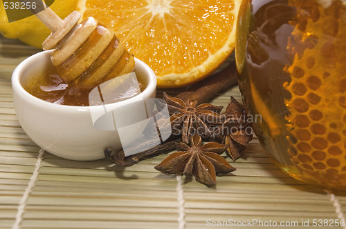 Image of fresh honey with honeycomb, spices and fruits