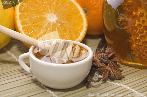 Image of fresh honey with honeycomb, spices and fruits