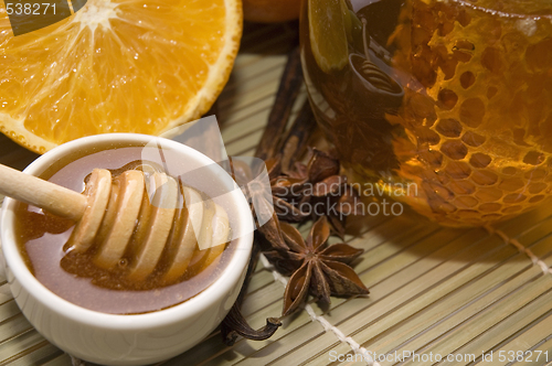 Image of fresh honey with honeycomb, spices and fruits