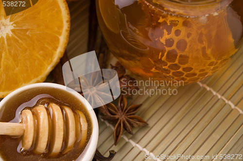 Image of fresh honey with honeycomb, spices and fruits