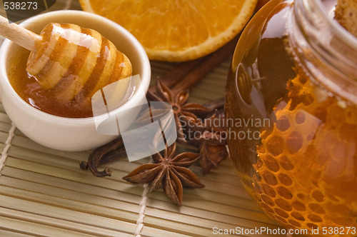 Image of fresh honey with honeycomb, spices and fruits