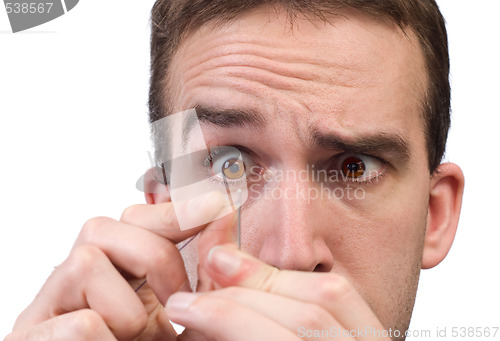 Image of Man Threading A Needle