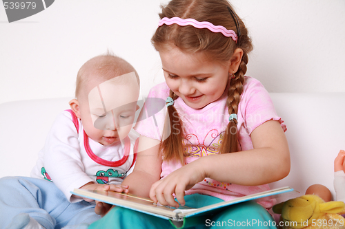 Image of Adorable kids reading and playing