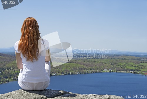 Image of Young woman on top of a mountain