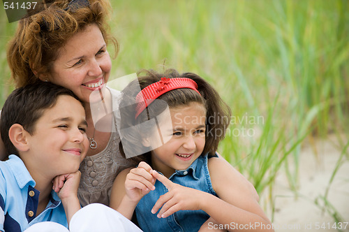 Image of happy mother and kids on the beach