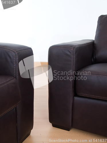 Image of Detail of two brown leather sofas