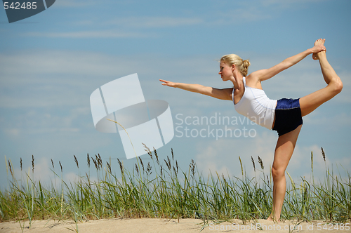 Image of Beautiful female workout on the beach