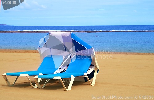 Image of Two sun-beds on the beach