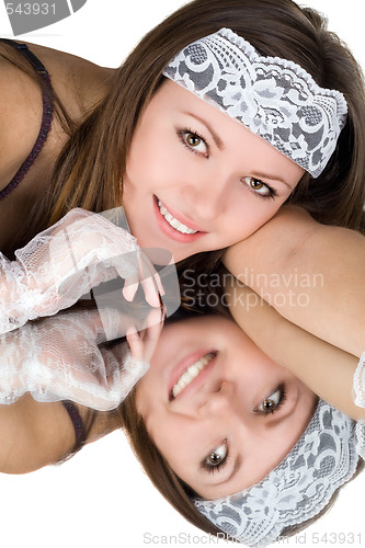 Image of Portrait of the young woman laying on a mirror