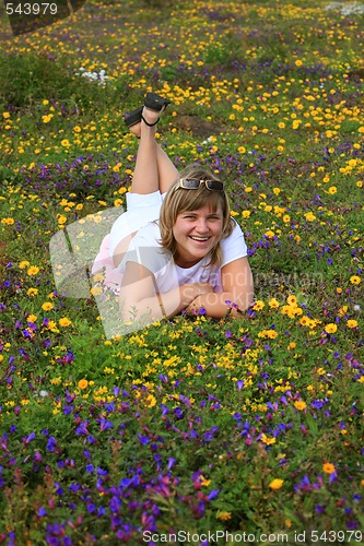 Image of Young girl enjoying on a flowers meadow