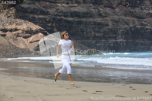 Image of Running woman on the beach