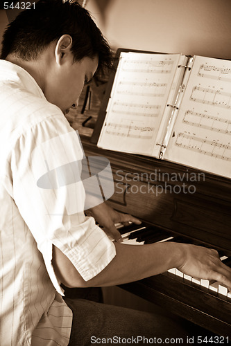 Image of Asian man playing piano