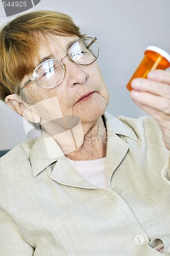 Image of Elderly woman with pill bottle