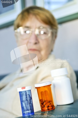 Image of Elderly woman with pill bottles