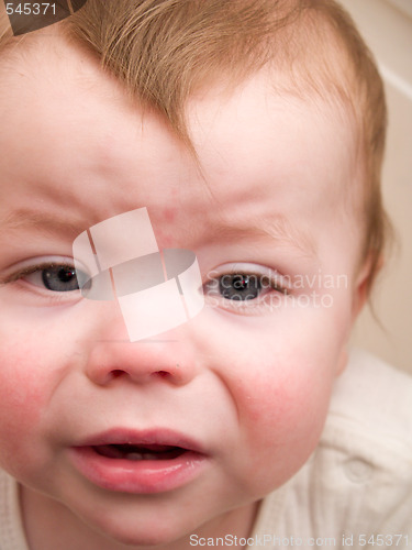 Image of Cute young baby boy looking at you