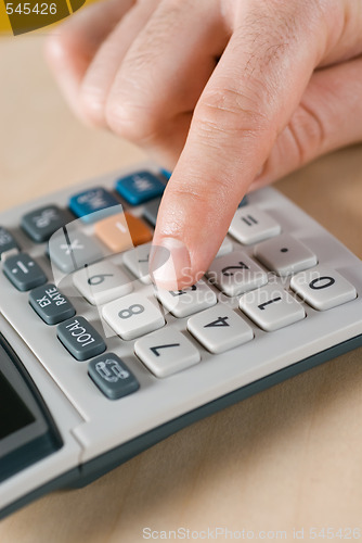 Image of male hand and calculator