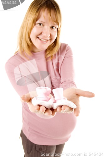 Image of pregnant woman holding pair of socks 