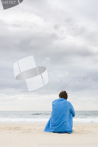 Image of Lonely woman sitting on beach