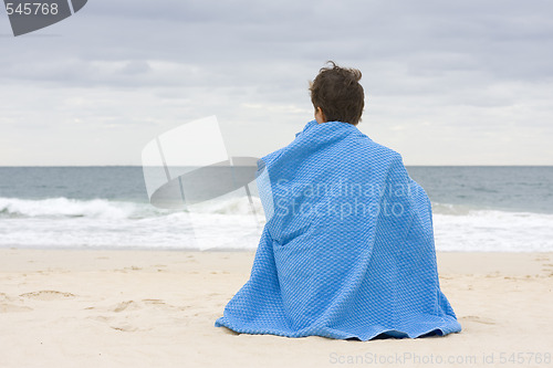 Image of Woman sitting on the beach