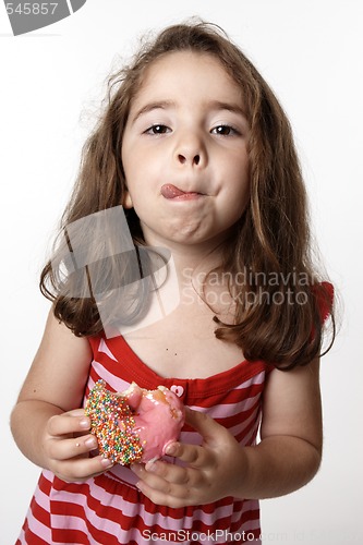 Image of Girl eating doughnut licking lips