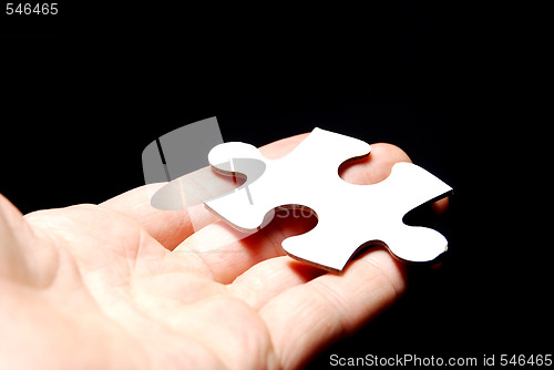 Image of Hand holding a puzzle piece