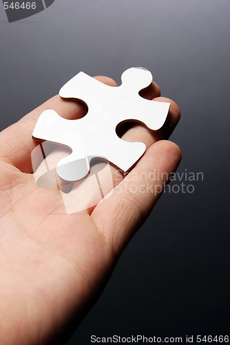 Image of Hand holding a puzzle piece