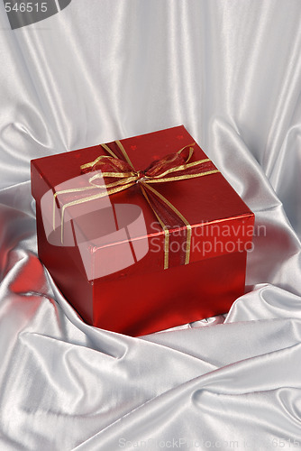 Image of red gift box on white satin