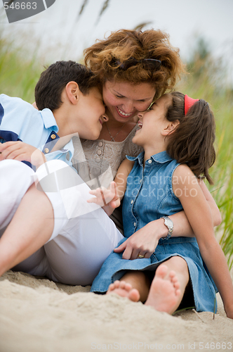 Image of Happy mother and kids on the beach