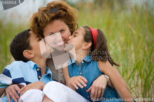 Image of Happy mother and kids on the beach