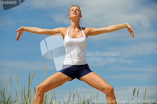 Image of Beautiful blond female workout on the beach