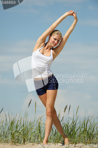 Image of Beautiful female workout on the beach