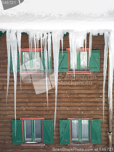 Image of Green wooden windows with  ice stalactites