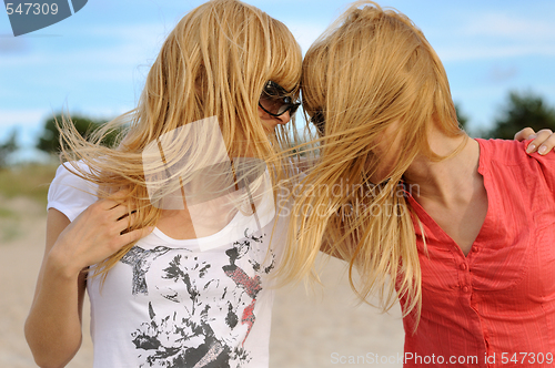 Image of Blond twins having fun on the beach