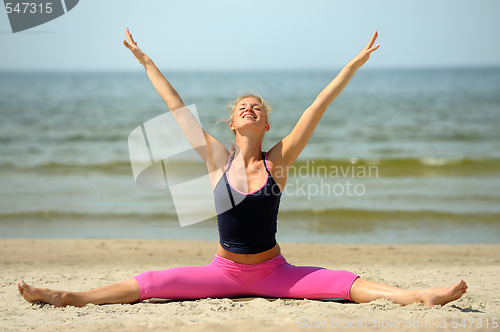 Image of Beautiful female workout on the beach