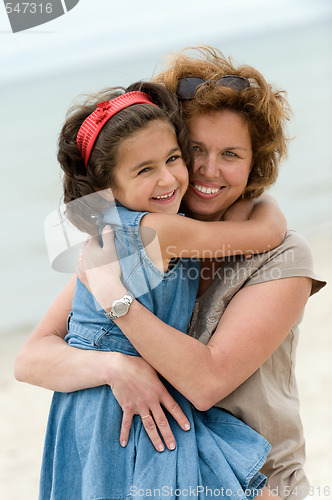 Image of Happy mother and kid on the beach