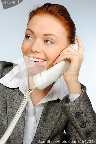 Image of Beautiful businesswoman calling