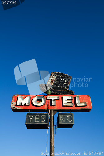 Image of motel sign against blue sky