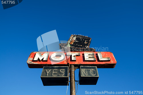 Image of motel sign against blue sky