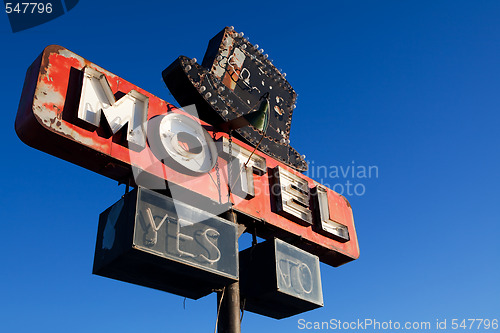 Image of retro motel sign blue sky