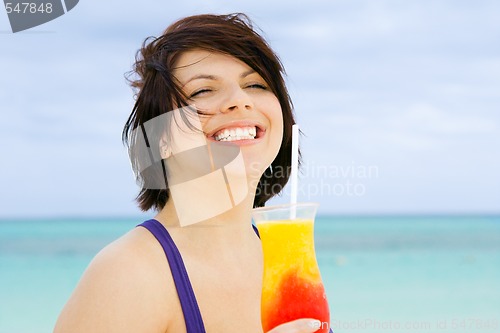 Image of happy woman with colorful cocktail