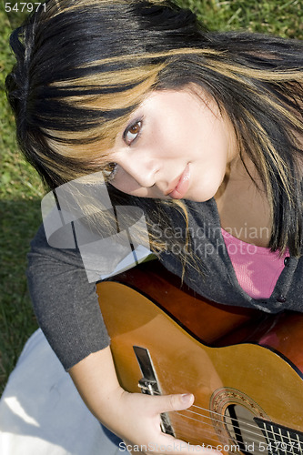 Image of Girl Playing a Guitar