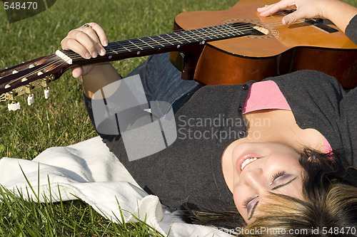 Image of Girl Playing a Guitar