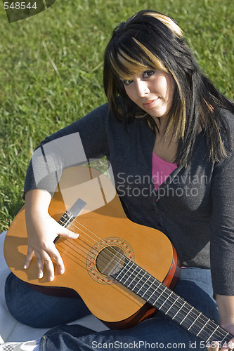 Image of Girl Playing a Guitar