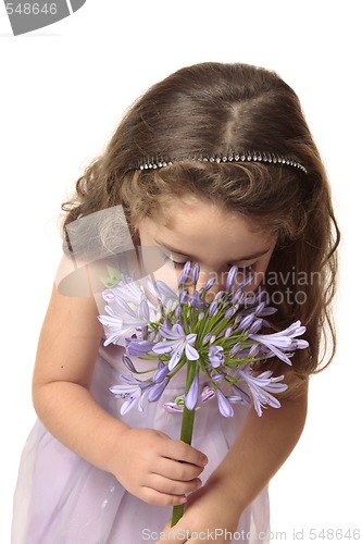 Image of Young girl sniffing flower