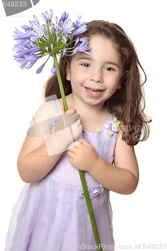 Image of Little girl holding large african lily - agapanthus