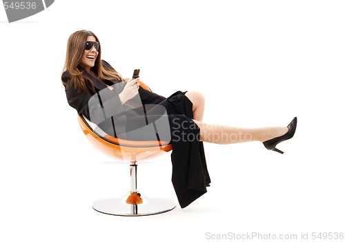 Image of businesswoman with phone in orange chair