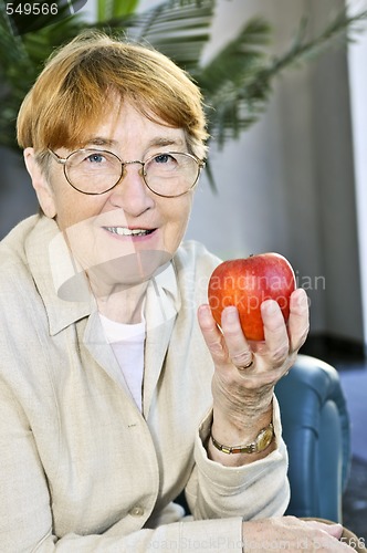 Image of Elderly woman with apple