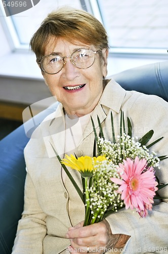 Image of Elderly woman with flowers