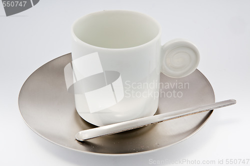 Image of White coffe cup with metal saucer on white.