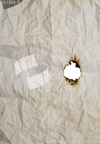 Image of burnt hole in wrinkled paper
